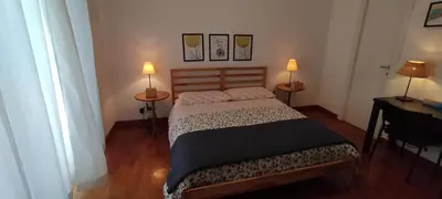 a bedroom with a bed and two lamps on two tables at Pigneto Suite appartamento 50 m da metro C in Rome