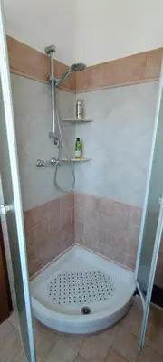 a shower in a bathroom with a tiled floor and a shower at Pigneto Suite appartamento 50 m da metro C in Rome