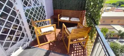 two chairs and a table on a balcony at Pigneto Suite appartamento 50 m da metro C in Rome