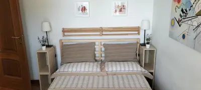 a bedroom with a bed with two night stands at Pigneto Suite appartamento 50 m da metro C in Rome
