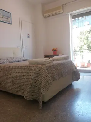 a bedroom with a bed with a blanket and a window at Apartament Silvy Trastevere in Rome