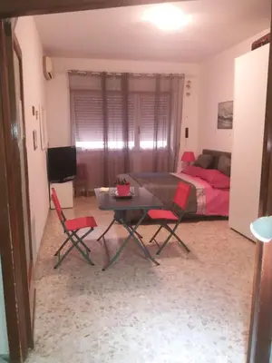 a living room with a table and chairs and a bed at Apartament Silvy Trastevere in Rome