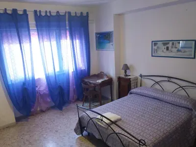 a bedroom with a bed and a desk and a window at Apartament Silvy Trastevere in Rome