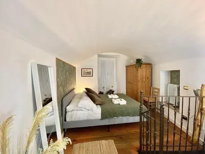 a bedroom with a bed with a cat laying on it at Karma House Deluxe Navona in Rome