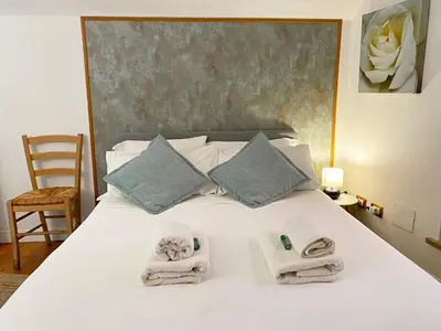 a bedroom with a white bed with towels on it at Karma House Deluxe Navona in Rome