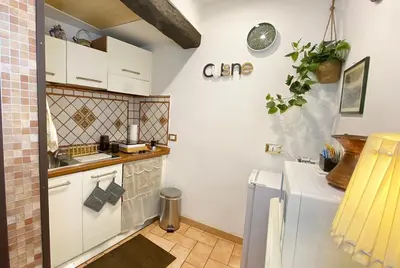 a small kitchen with a sink and a refrigerator at Karma House Deluxe Navona in Rome