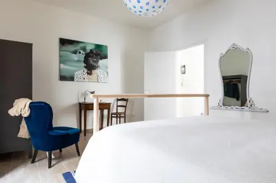 a bedroom with a bed and a table and chairs at Casa Otto in Rome
