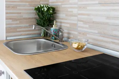 a kitchen counter with a stainless steel sink at Casa Otto in Rome