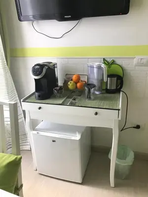 a white table with fruits and a coffee maker on it at Vatican City Holidays Guesthouse in Rome