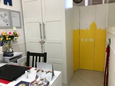 a room with a desk and a yellow door at Vatican City Holidays Guesthouse in Rome