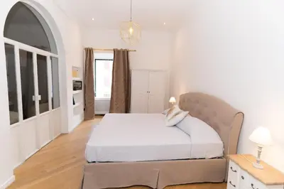 a white bedroom with a bed and a window at Luxury Laura Vatican Apartment ROMA CENTRO in Rome