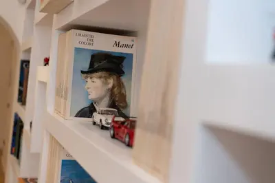 a shelf with a picture of a woman with a toy car at Luxury Laura Vatican Apartment ROMA CENTRO in Rome