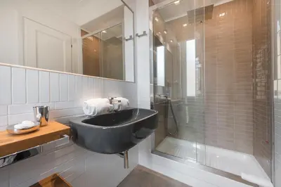 a bathroom with a black sink and a shower at Le Stanze Di Elle in Rome