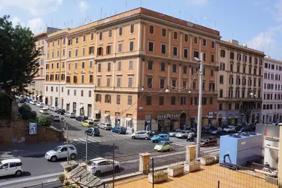 a city street with cars parked in front of a building at Le Stanze Di Elle in Rome