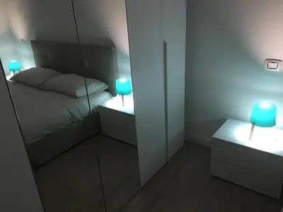a bedroom with a mirror and a bed with blue lights at GLI ARANCI Apartment in Rome