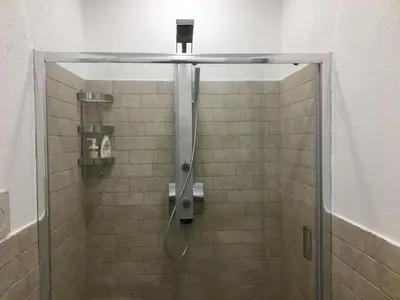 a shower with a glass door in a bathroom at GLI ARANCI Apartment in Rome