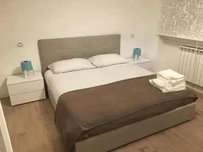 a bedroom with a large bed and two night stands at GLI ARANCI Apartment in Rome