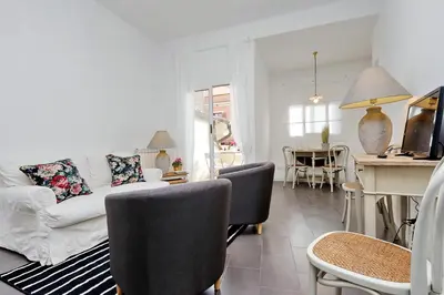 a living room with a white couch and chairs at Monti charming apartment - Rome short let Service in Rome