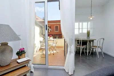 a living room with a door open to a balcony with a table at Monti charming apartment - Rome short let Service in Rome