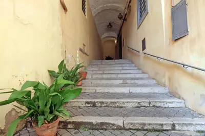 a staircase in a building with some plants at Monti charming apartment - Rome short let Service in Rome