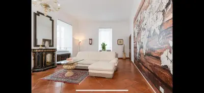 a living room with a white couch and a table at IN FRONT OF COLISEUM 2 in Rome