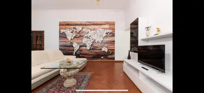 a living room with a map of the world on the wall at IN FRONT OF COLISEUM 2 in Rome