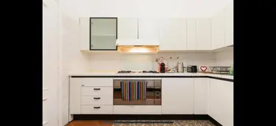 a kitchen with white cabinets and a stove top oven at IN FRONT OF COLISEUM 2 in Rome