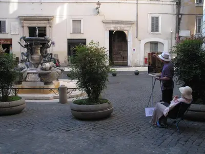 a woman sitting in a chair in front of a fountain at Indimenticabili VACANZE ROMANE nel cuore della città in Rome