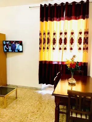 a living room with a table and a curtain at COLOSSEUM LUXURY ROOM in Rome