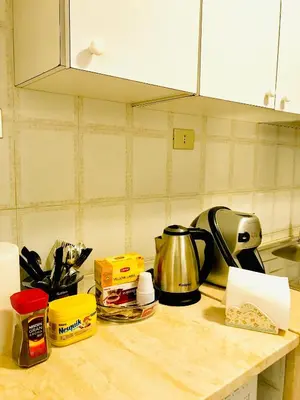a kitchen counter with a coffee pot and other kitchen items at COLOSSEUM LUXURY ROOM in Rome