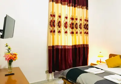 a bedroom with a bed and a desk and a curtain at COLOSSEUM LUXURY ROOM in Rome