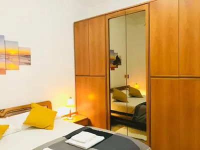 a bedroom with a bed and a large mirror at COLOSSEUM LUXURY ROOM in Rome