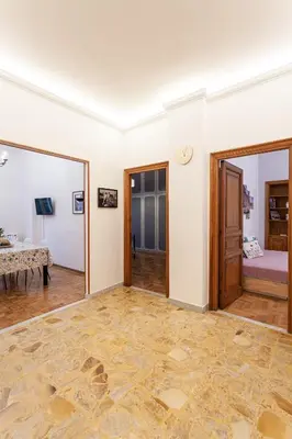 an empty living room with a table and a bed at Il Melograno Holiday House in Rome