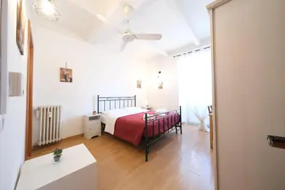 a bedroom with a bed and a ceiling fan at Gialel Guesthouse in Rome
