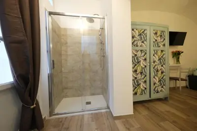 a shower with a glass door in a bathroom at Gialel Guesthouse in Rome