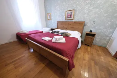 a bedroom with two beds with towels on them at Gialel Guesthouse in Rome