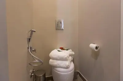 a bathroom with a toilet with a towel on it at 126 Gracchi Suites in Rome