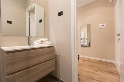 a bathroom with a sink and a mirror at 126 Gracchi Suites in Rome