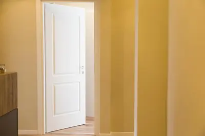 an open door in a room with yellow walls at 126 Gracchi Suites in Rome