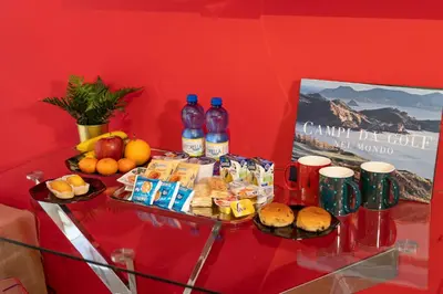 a table with two plates of food and bottles of soda at Vaticano84 in Rome
