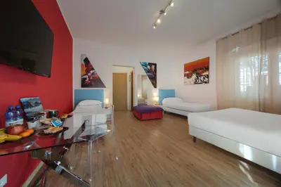 a living room with a white couch and a red wall at Vaticano84 in Rome