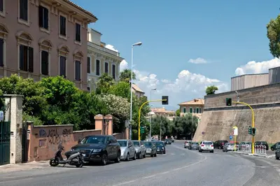 a street with cars parked on the side of the road at Vaticano84 in Rome