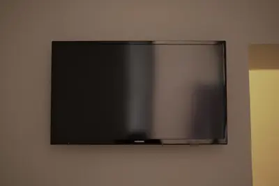 a flat screen tv hanging on a wall at Arcadia apartments in Rome