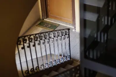 a stairway leading to a door with a rug at Arcadia apartments in Rome