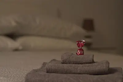 a red statue sitting on top of a bed at Arcadia apartments in Rome