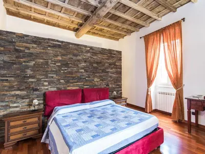 a bedroom with a bed and a brick wall at Apartment Domus Fori by Interhome in Rome