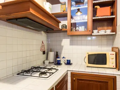 a kitchen with a stove and a microwave at Apartment Domus Fori by Interhome in Rome