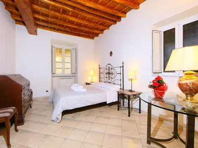 a large bedroom with a bed and a table at Apartment Vittorio Emanuele-1 by Interhome in Rome
