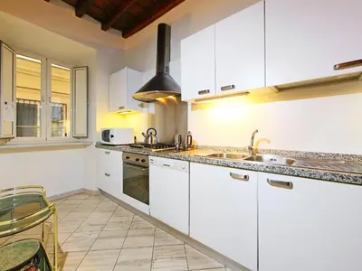 a kitchen with white cabinets and a sink at Apartment Vittorio Emanuele-1 by Interhome in Rome