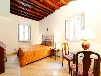 a bedroom with a bed and a table at Apartment Vittorio Emanuele-1 by Interhome in Rome
